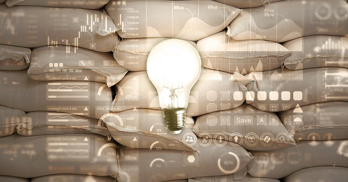 The image of a lightbulb and various charts and graphs overlaid on top of a stack of white bags of feed.